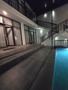 an empty swimming pool in a building with a swimming pool at Serenity Nirvana Palace -Private Rooms & Suitable for families Jimbaran in Jimbaran