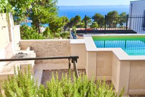 a villa with a swimming pool and a resort at GV - Holiday home with MagnaPool in Makarska