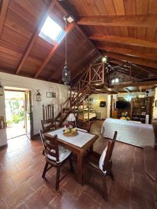 a dining room with a table and a bed at Casa terrera "El Granero" in Tanque
