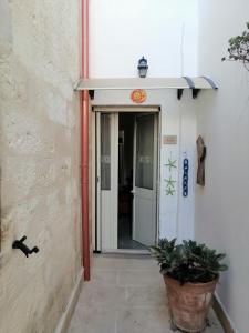 an entrance to a building with a door and a plant at A casa di Marisa in Casamassella