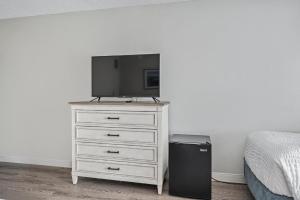 a bedroom with a dresser with a television on it at First Floor Standard Deluxe King in North East