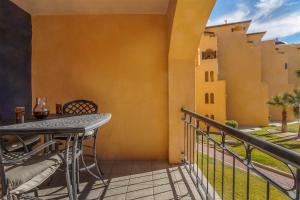 a balcony with a table and a view of a building at Princesa De Penasco in Punta Penasco New