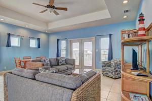 a living room with a couch and a tv at Casa Las Palmas - Pet Friendly! Boardwalk to the Beach! in Mustang Beach