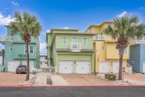 a row of houses with palm trees in front at Eleventh Street in Mustang Beach