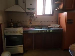 a kitchen with a sink and a stove top oven at SumayWasi in Tilcara