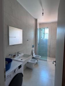 une salle de bain avec un lavabo, des toilettes et une douche dans l'établissement VILLA MYRTAJ, à Saranda