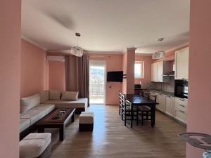 a living room with a couch and a table at Villa Myrtaj - Luxury Private Pool in Sarandë