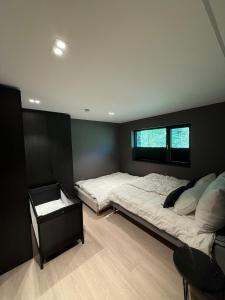 a bedroom with a large bed and a window at Villa Vaaganeset in Lii +36 photos