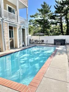 a swimming pool in front of a house at Collins avenue 26 in Dewey Beach
