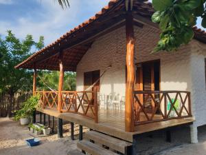 a house with a deck with chairs on it at SwissChalet Hp-Kite in Barra Grande
