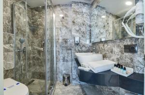 a bathroom with a shower and a sink and a toilet at Gen Suites in Istanbul