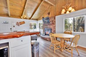 a kitchen and dining room with a table and a fireplace at Storyville #2294 in Big Bear Lake