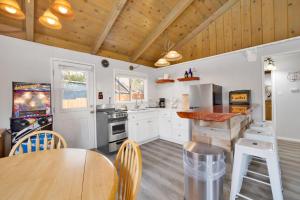 a kitchen with white cabinets and a wooden ceiling at Storyville #2294 in Big Bear Lake +7 photos