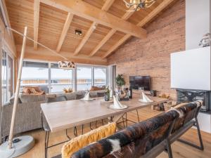 a dining room with a table and a couch at Kreischberg The Exclusive Eight in Sankt Lorenzen ob Murau