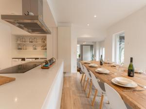 a kitchen with a long wooden table and chairs at La Ciotat in Sint-Idesbald