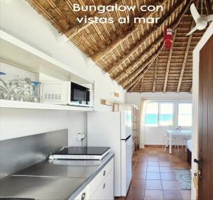 a kitchen with white cabinets and a counter top at Mandala Bungalows - Adults Only in Los Caños de Meca