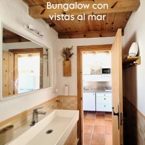 a bathroom with a sink and a mirror at Mandala Bungalows - Adults Only in Los Caños de Meca +37 photos
