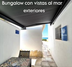 a balcony with a table and a chair in a building at Mandala Bungalows - Adults Only in Los Caños de Meca