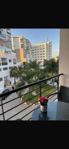 a balcony with a table and a view of a city at Hanae malabata in Tangier