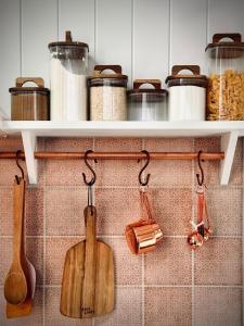 a kitchen with wooden utensils on a wall at The Orangerie in Hobart +16 photos
