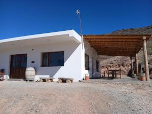 a small white building with a wooden roof at Casa Florencia in Cachí