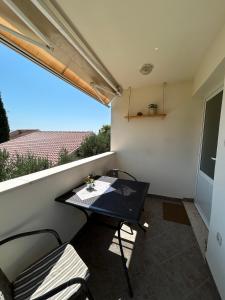 a small balcony with a black table and chairs at Apartments with parking space Orebic, Peljesac - 10082 in Orebić +28 photos