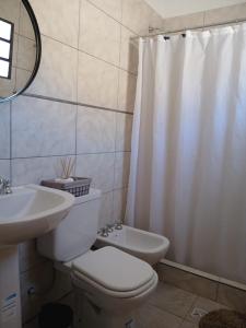 a bathroom with a toilet and a sink and a shower at Casa Florencia in Cachí +10 photos