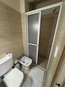 a small bathroom with a toilet and a shower at Apart Chacabuco in San Fernando del Valle de Catamarca