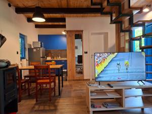 a living room with a flat screen tv on a table at Blue House in Netretić