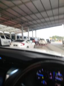 a car dashboard with cars parked in a parking lot at Hotel in Puunggolaka