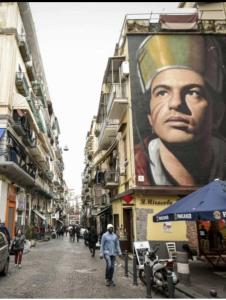 a large painting of a woman on the side of a building at Tp luxury in Naples