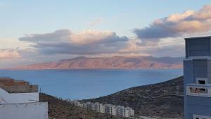 a view of a body of water with buildings and mountains at Safay Al Hoceima nr 5 in Al Hoceïma