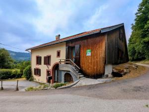a building with a staircase on the side of it at Gîte Authentique en Ferme Vosgienne, Nature et Confort près de Gérardmer - FR-1-589-211 in Liézey