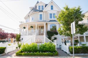 a white house with a white fence at Coastal Chateau in Ocean City