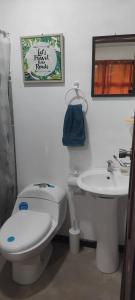 a bathroom with a toilet and a sink at La casita de Antonio en Sarapiqui in Llano Grande