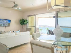 a living room with a table and a couch at Playa Blanca Premier Unit 504 in San Carlos