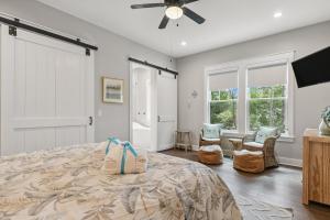 a bedroom with a bed and a ceiling fan at Aquamarine! Sleeps 12! Close to Community Pool! Private Beach Access! in Blue Mountain Beach +96 photos