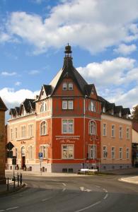 a large red building with a black roof at In Piazza in Bad Klosterlausnitz