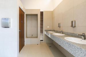 a bathroom with three sinks and two mirrors at Viva Jaco in Jacó