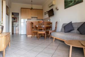 a living room with a couch and a table at Photographer's Apartments in Alikanas +59 photos