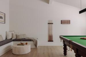 a living room with a pool table and a couch at The Ambers at Port Stephens in Bobs Farm
