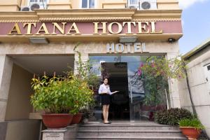 a woman standing in the doorway of aania hotel at Atana Airport Hotel in Ho Chi Minh City
