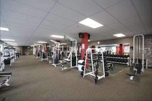 a gym with a lot of equipment in a room at Le Cardinal in Rouyn-Noranda