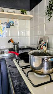 a kitchen with a sink and a pot on a stove at Celina's Cozy Studio & Beach Life in One in Santa Maria +2 photos