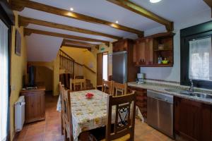 a kitchen with a table and a kitchen with a sink at Alojamientos Rurales Hurdes Altas in Casares de las Hurdes