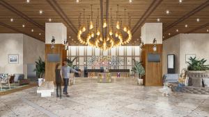 a man and woman standing in a lobby with a chandelier at The Royal Park Hotel Maihama Resort Tokyo Bay in Urayasu