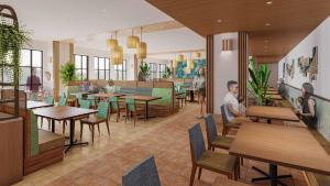 a restaurant with tables and people sitting at tables at The Royal Park Hotel Maihama Resort Tokyo Bay in Urayasu