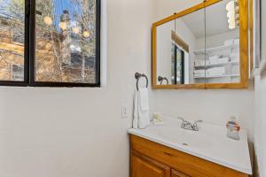 a bathroom with a sink and a mirror at Mescalero Flagstaff in Munds Park +20 photos