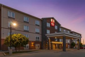 a hotel with a sign on the side of a building at Best Western Plus Winnipeg West in Winnipeg