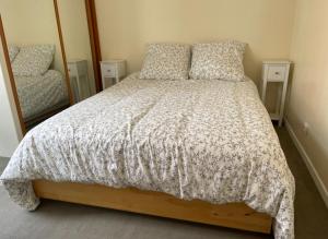 a bedroom with a bed and a large mirror at Lovely house with garden Paris Flea Market in Saint-Ouen